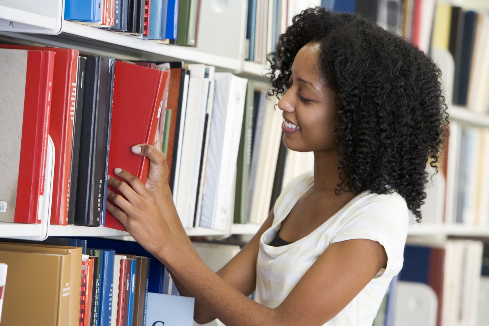 Eine Wissenschaftlerin und ein Wissenschaftler arbeiten hinter einer Glasfassade und mischen Chemikalien mit Großgeräten.